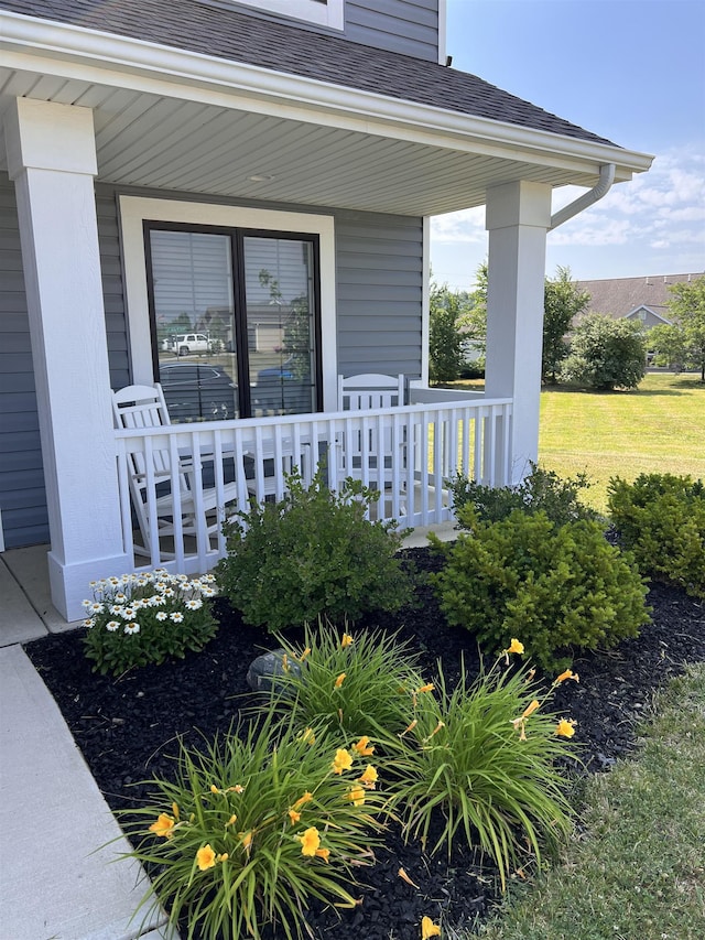 entrance to property with a yard and a porch