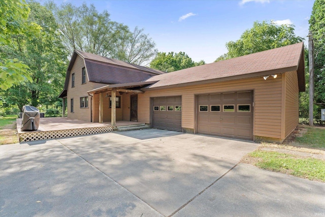 view of front of property featuring covered porch and a garage