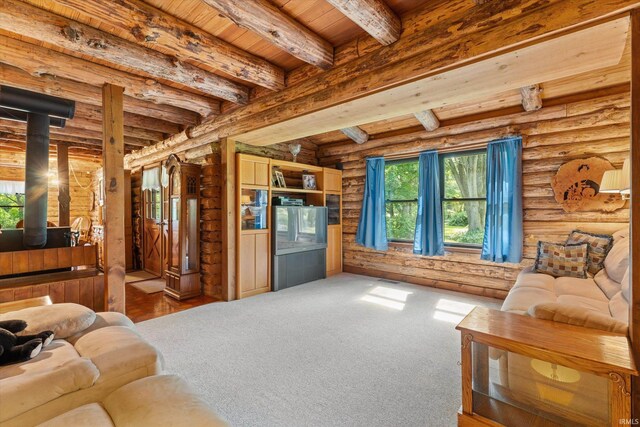 living room with beam ceiling, rustic walls, and wooden ceiling