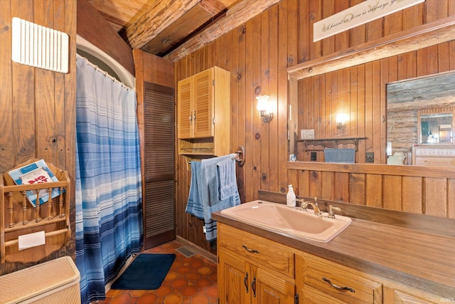 bathroom featuring tile patterned floors, vanity, and wooden walls