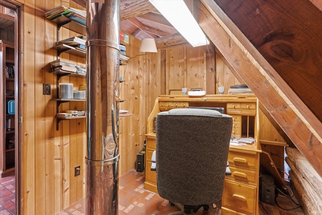 office area featuring wooden walls and vaulted ceiling