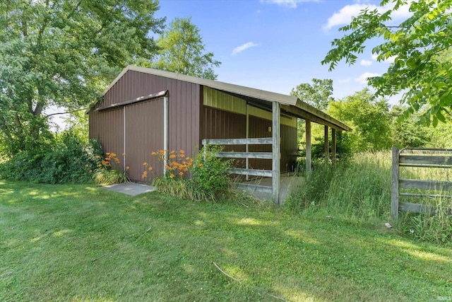 view of outbuilding featuring a yard