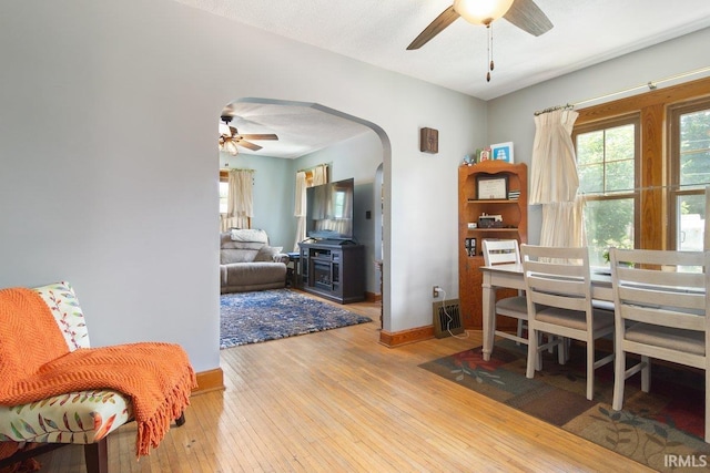 dining area with hardwood / wood-style flooring and ceiling fan