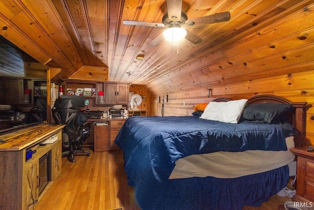 bedroom with vaulted ceiling, light hardwood / wood-style flooring, wood walls, ceiling fan, and wood ceiling