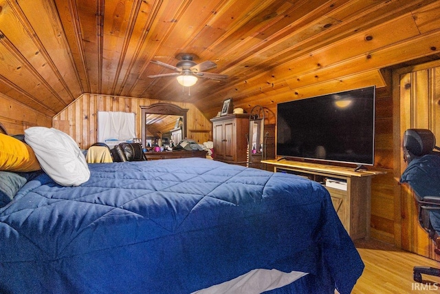 bedroom with wood walls, light hardwood / wood-style flooring, wood ceiling, and lofted ceiling