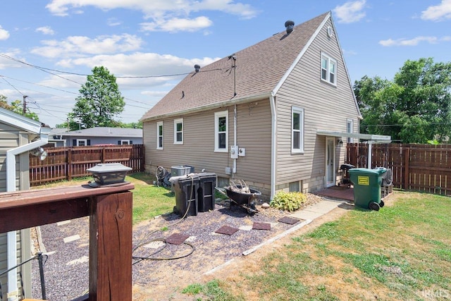 rear view of house featuring a lawn