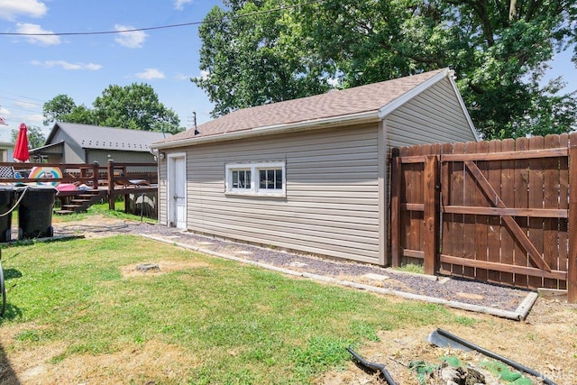 view of property exterior with a lawn and a deck