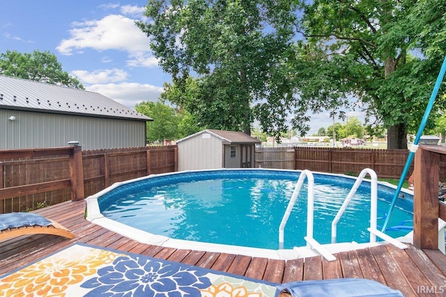 view of pool with a deck and a storage shed