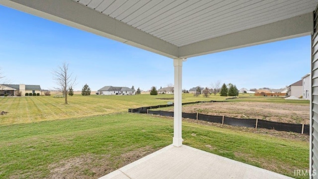 view of yard featuring a residential view and a patio