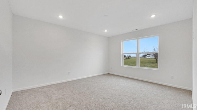 spare room with carpet floors, recessed lighting, and baseboards