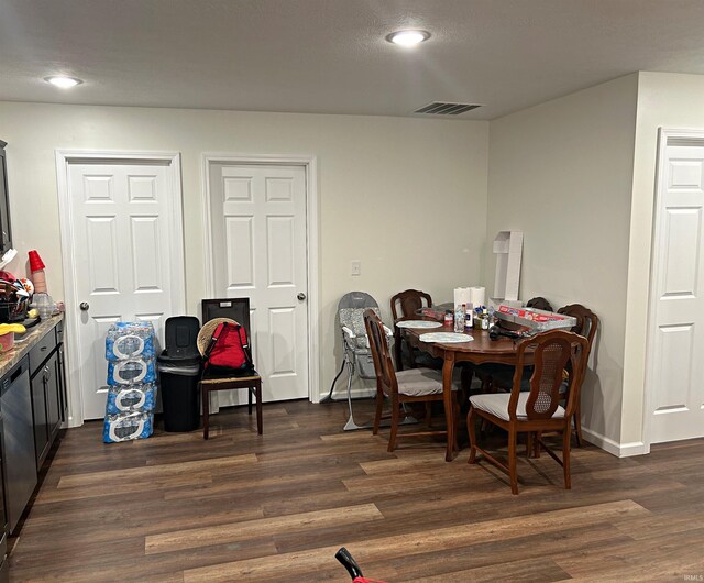dining area with dark hardwood / wood-style flooring