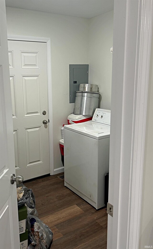 clothes washing area with dark wood-type flooring and washer / clothes dryer