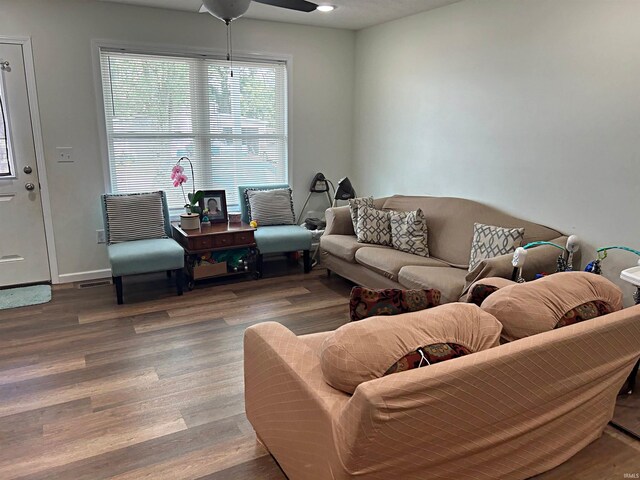 living room featuring hardwood / wood-style flooring and ceiling fan