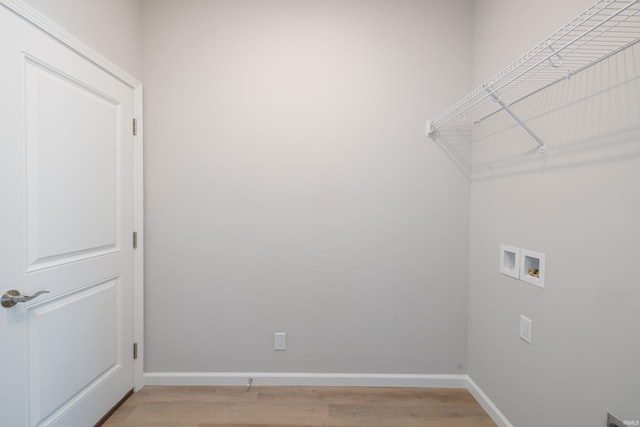 clothes washing area with washer hookup and light hardwood / wood-style floors