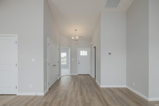 entryway featuring a chandelier and light hardwood / wood-style flooring