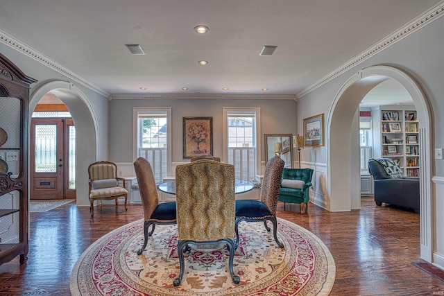 dining space with built in shelves, crown molding, and dark wood-type flooring