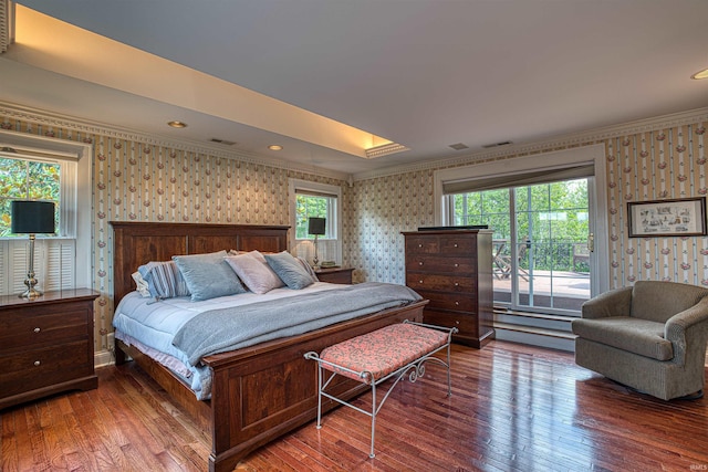 bedroom featuring multiple windows, hardwood / wood-style floors, and ornamental molding