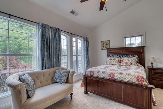 carpeted bedroom featuring ceiling fan, lofted ceiling, and multiple windows