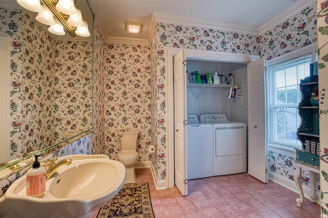 bathroom with ornamental molding, sink, separate washer and dryer, tile patterned flooring, and toilet