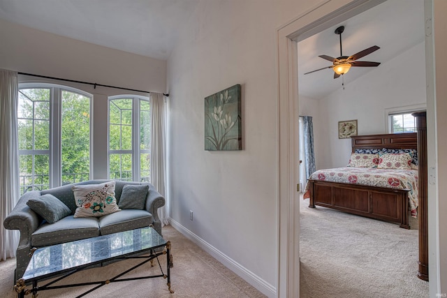 living room with ceiling fan, light carpet, and vaulted ceiling