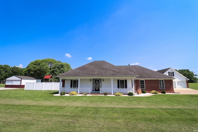 view of front of home featuring a front lawn, covered porch, and a garage