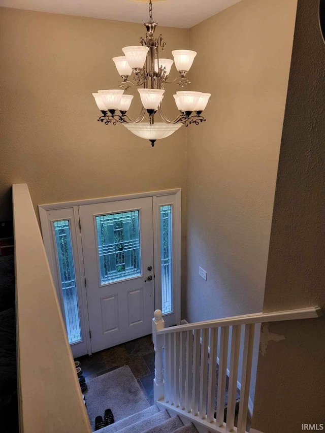 entrance foyer featuring an inviting chandelier