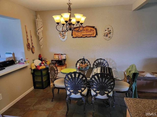 dining area featuring tile patterned floors and a notable chandelier