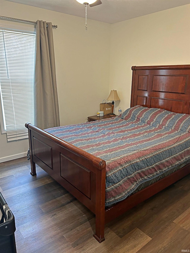 bedroom with ceiling fan and dark hardwood / wood-style flooring