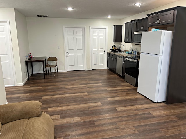 kitchen featuring dark hardwood / wood-style flooring, stainless steel appliances, and sink