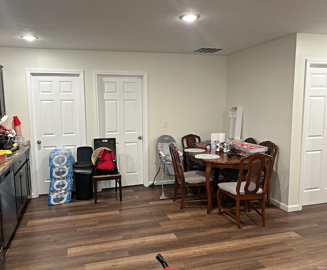 dining space featuring dark wood-type flooring