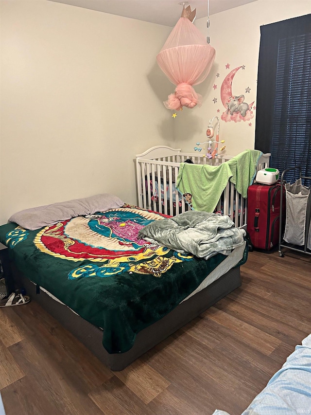 bedroom with dark hardwood / wood-style floors