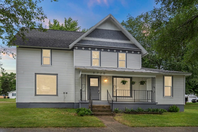 view of front facade featuring a lawn and a porch