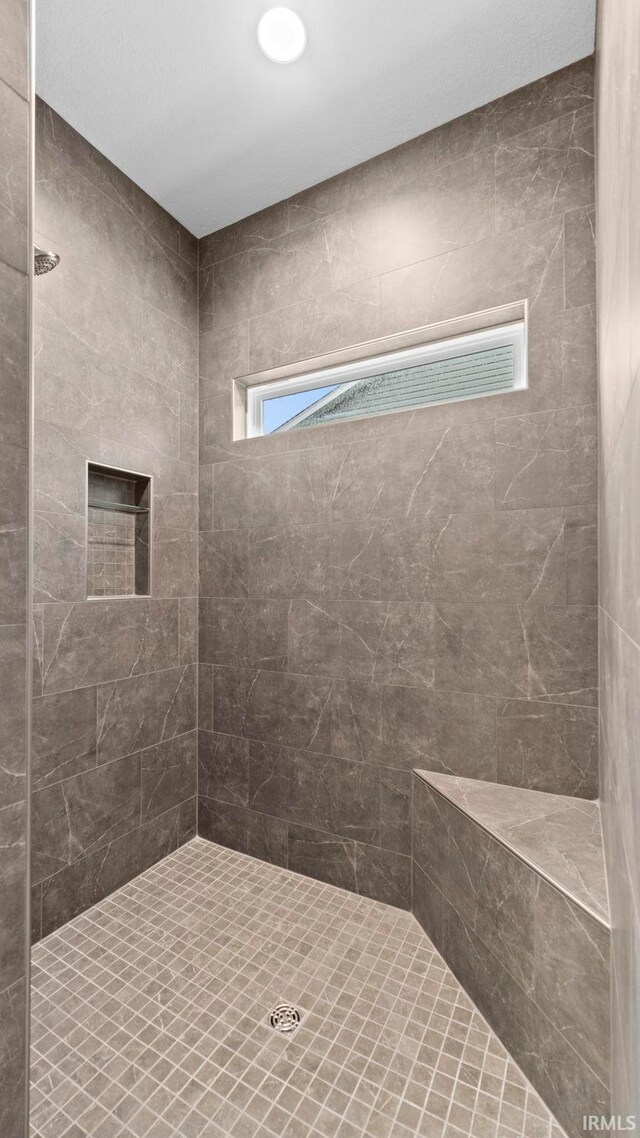 bathroom with a tile shower