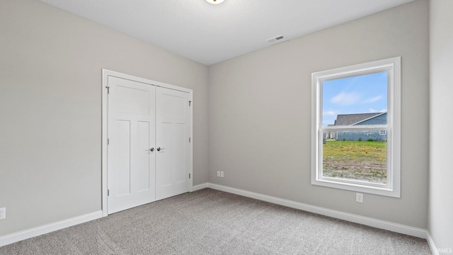 unfurnished bedroom featuring a closet and carpet