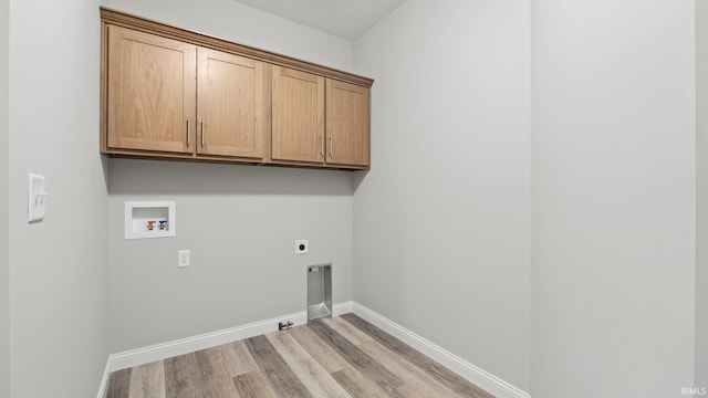 laundry room with electric dryer hookup, cabinets, gas dryer hookup, hookup for a washing machine, and light hardwood / wood-style flooring