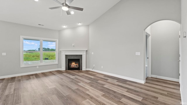 unfurnished living room featuring ceiling fan and light hardwood / wood-style flooring