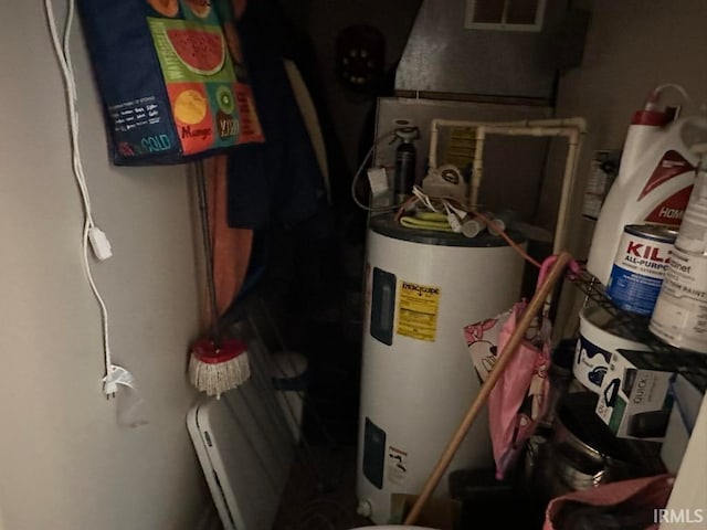 utility room featuring water heater