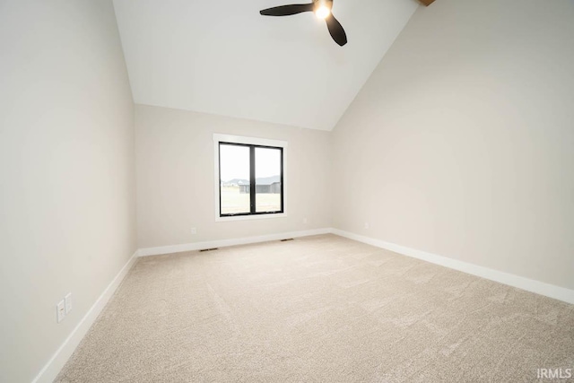 empty room with carpet, high vaulted ceiling, and ceiling fan