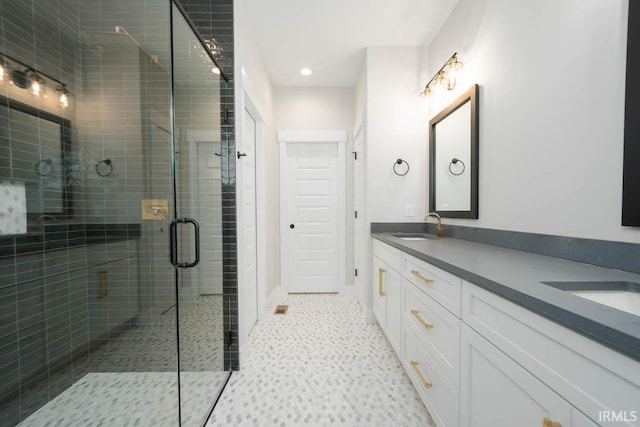 bathroom featuring vanity and a shower with shower door