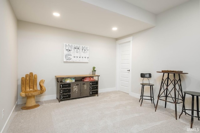 living area featuring light carpet