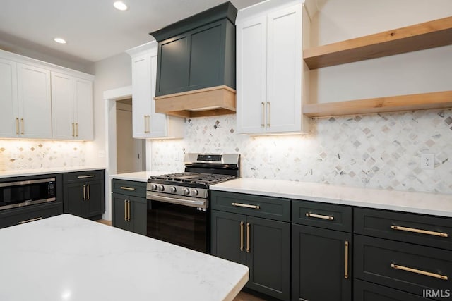 kitchen with white cabinets, custom range hood, stainless steel appliances, and tasteful backsplash