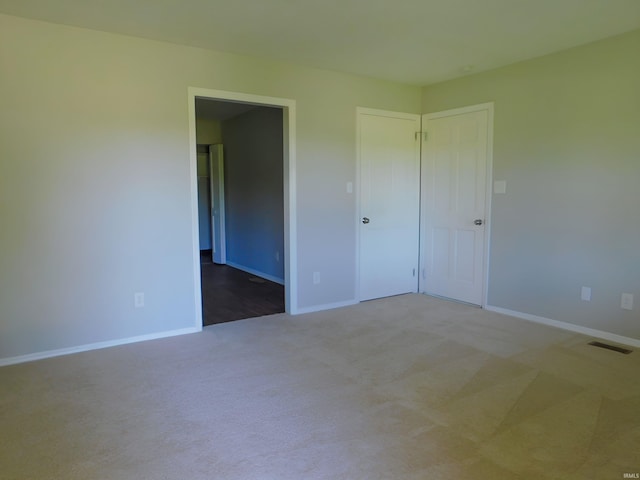 unfurnished bedroom with carpet floors and a closet