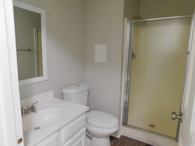 bathroom featuring vanity, hardwood / wood-style flooring, toilet, and an enclosed shower