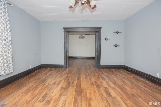 unfurnished room featuring dark hardwood / wood-style floors and ceiling fan