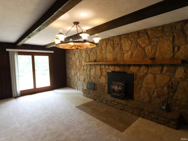 unfurnished living room with a chandelier, beamed ceiling, light colored carpet, and a textured ceiling