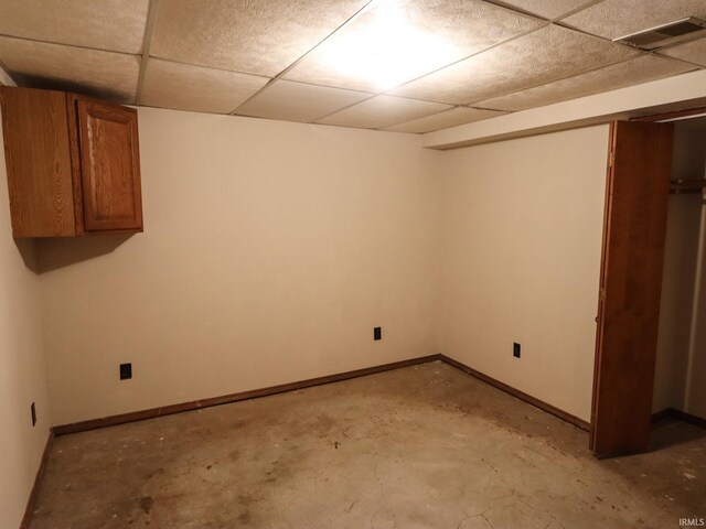 basement with a paneled ceiling