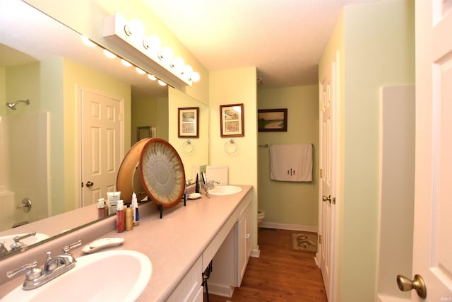 full bathroom featuring toilet, bathing tub / shower combination, hardwood / wood-style flooring, and vanity