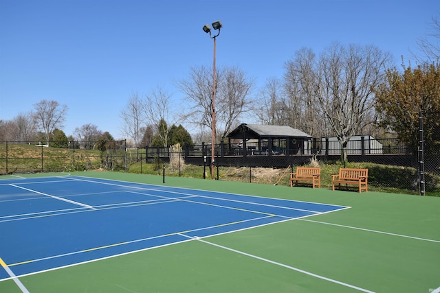 view of tennis court featuring basketball court and a gazebo