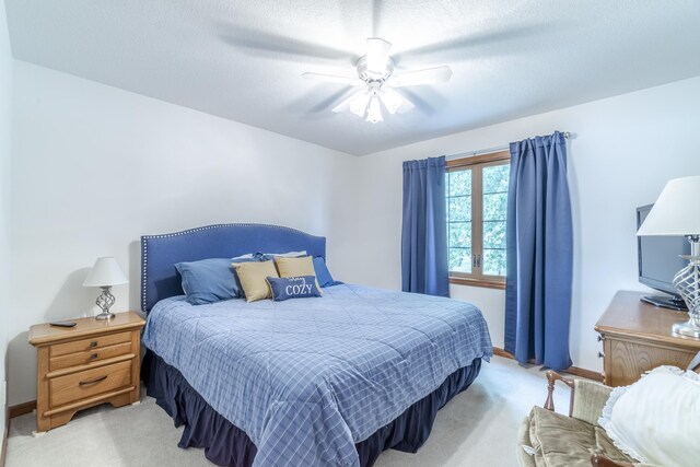 bedroom featuring light carpet and ceiling fan