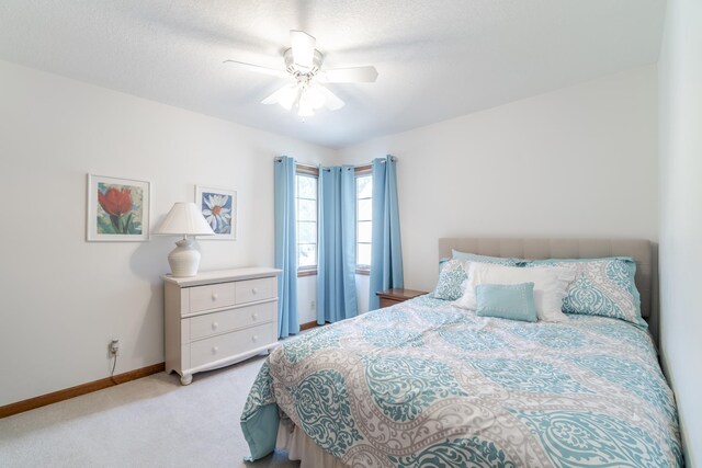 bedroom with multiple windows, carpet floors, and a textured ceiling